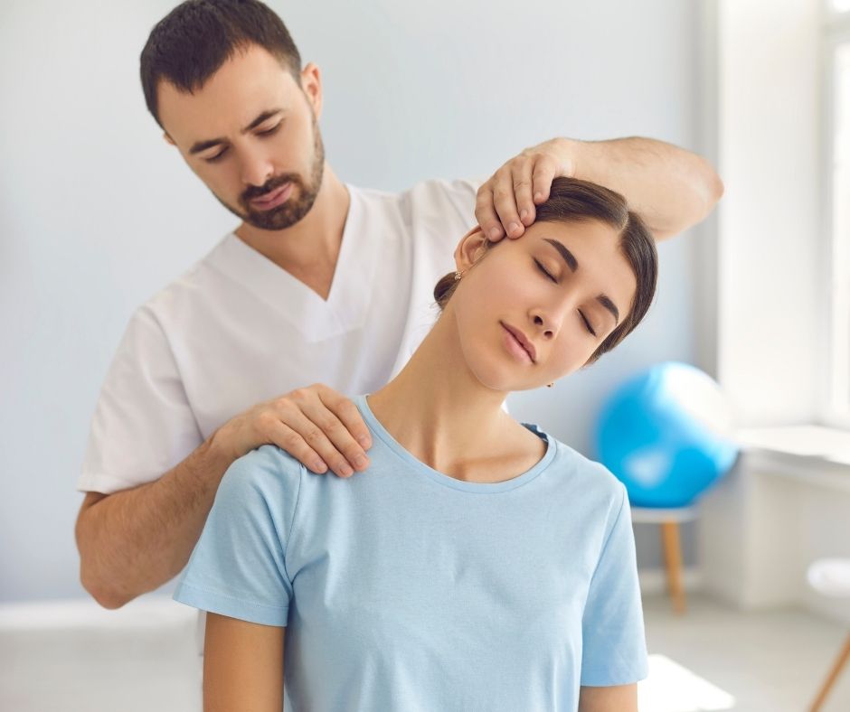 chiropractor adjusting woman's neck
